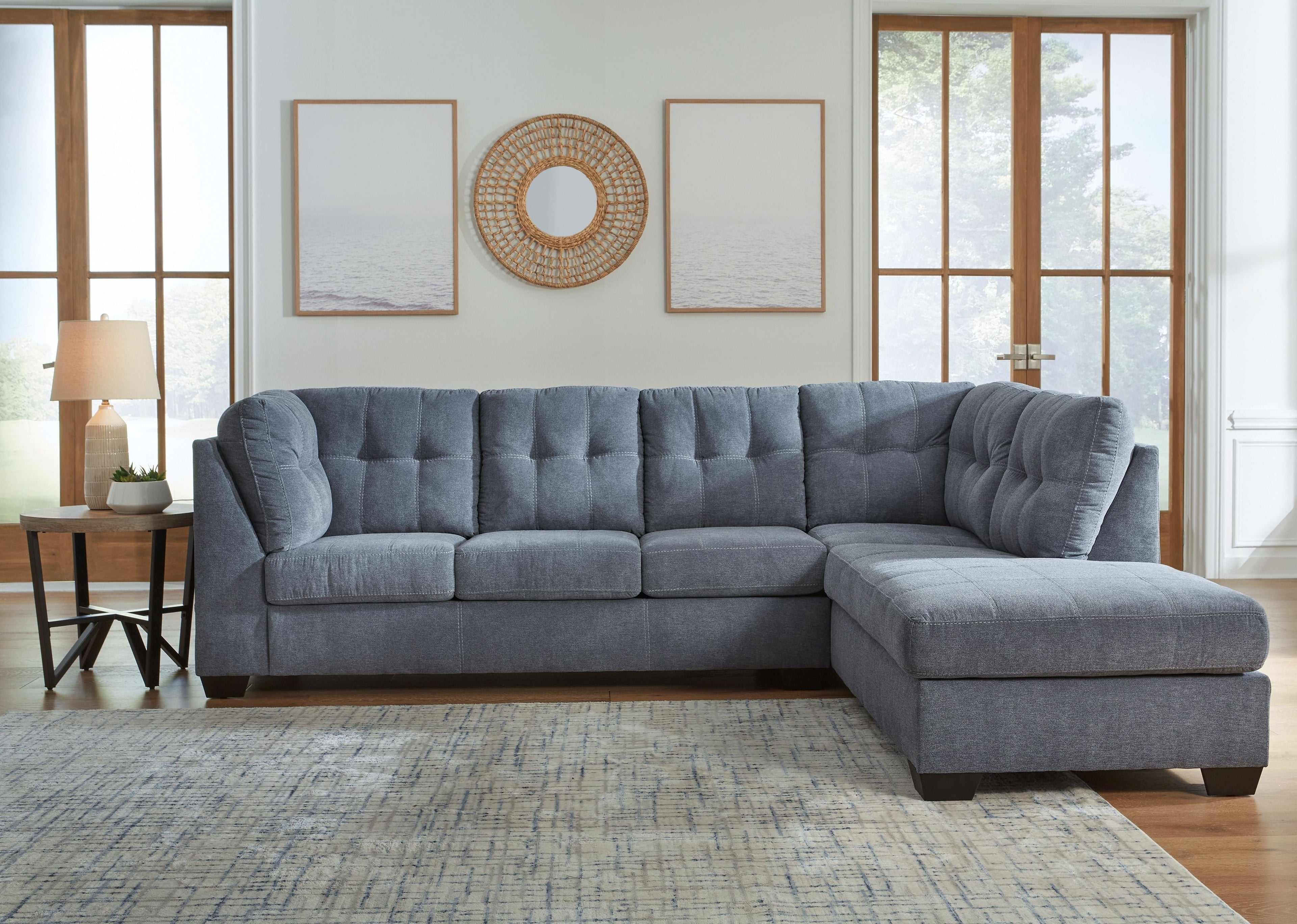 Gray sectional sofa with right-corner chaise, tufted back, and squared chaise arm