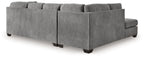 Gray corner chaise sectional sofa viewed from side, with square arms and tufted back