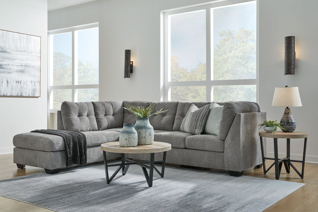 Gray corner chaise sectional sofa with tufted cushions and chaise armrest on the side