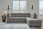 Gray corner chaise sectional sofa with tufted back cushions and chaise lounge