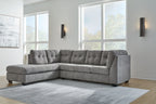 Gray sectional sofa with corner chaise, tufted back, and thick seat cushions in living room