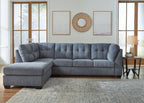 Gray sectional sofa with left-corner chaise, tufted back, and deep seat cushions