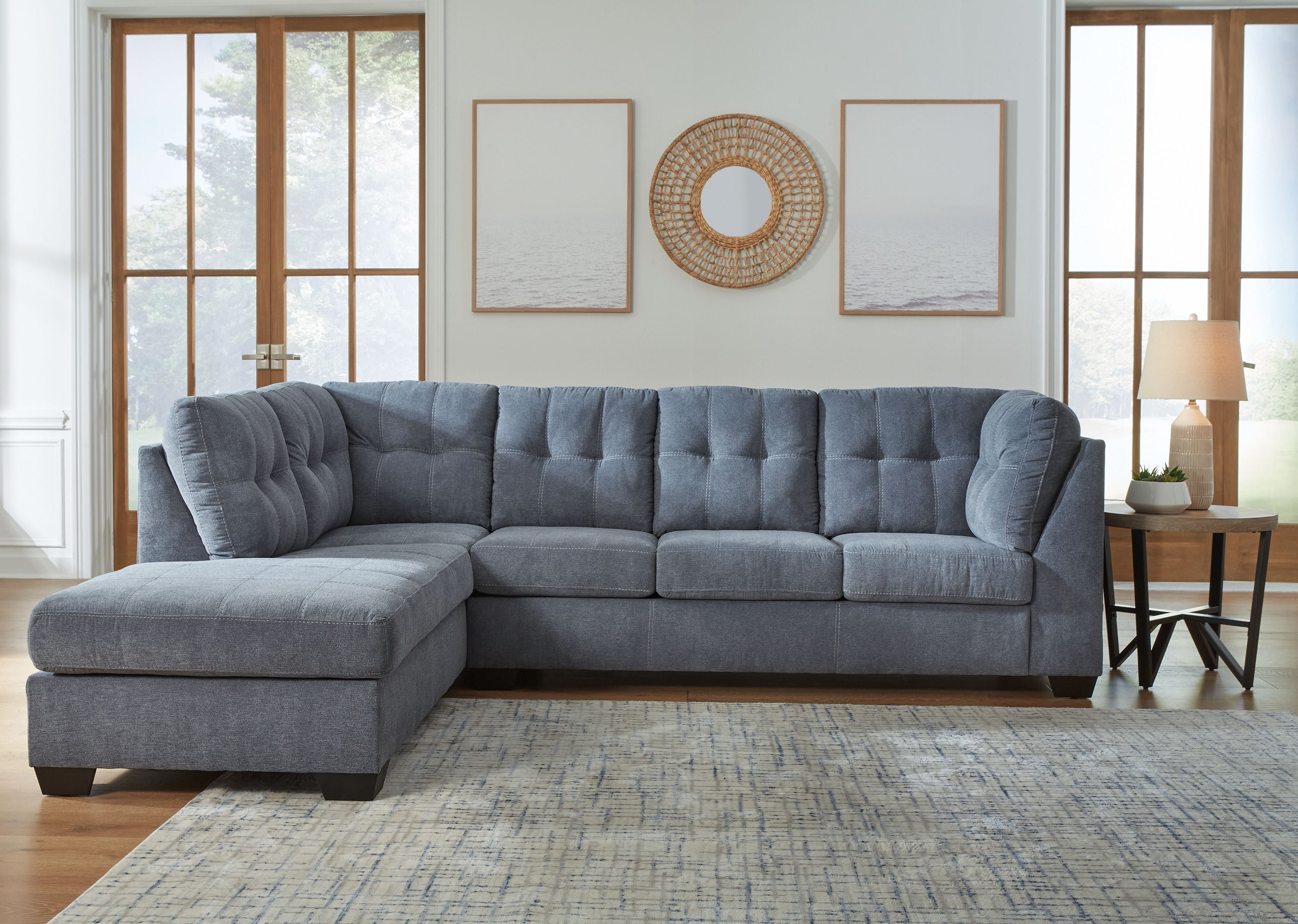 Gray sectional sofa with left-corner chaise, tufted back, and deep seat cushions