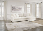 Ivory sectional sofa with corner chaise, low profile arms, and multiple lumbar pillows