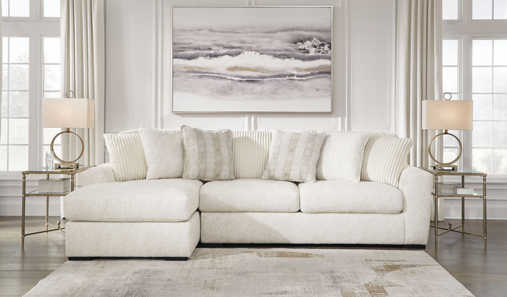 Ivory fabric sectional sofa with rounded chaise corner and multiple back cushions