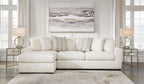 Ivory fabric sectional sofa with rounded chaise corner and multiple back cushions