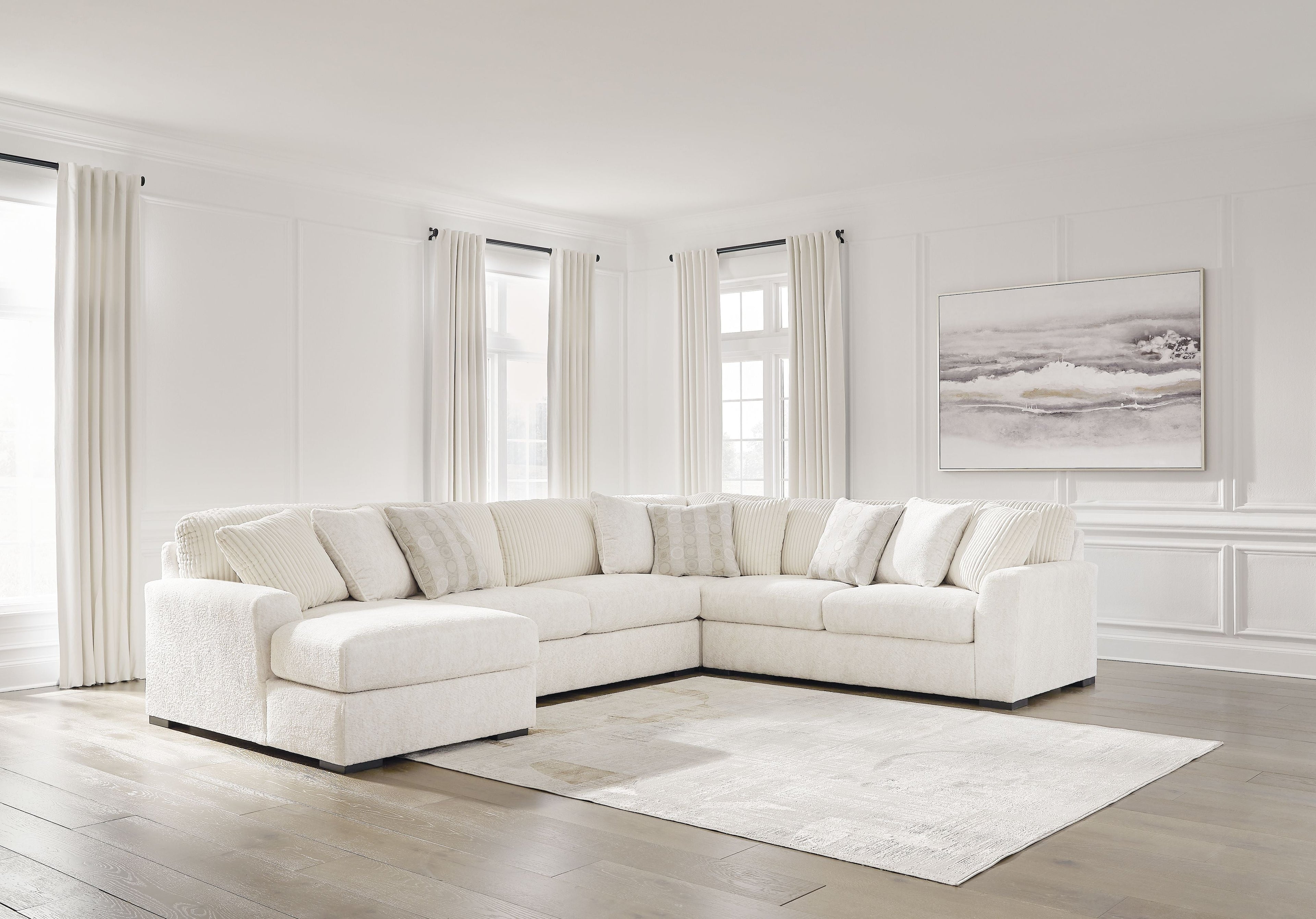 Ivory fabric sectional sofa with chaise arm and tufted seat cushions, corner design