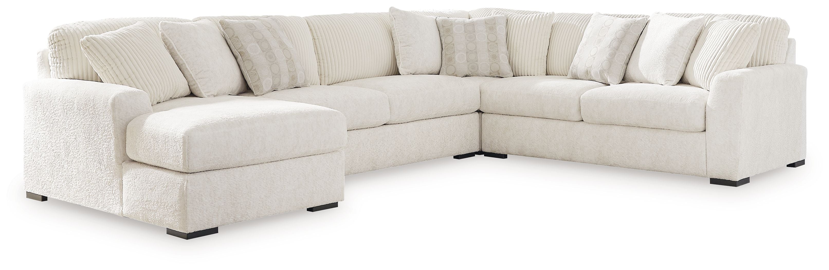 Ivory sectional sofa with corner chaise and wide armrests, featuring multiple back cushions