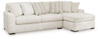 Ivory sectional sofa with corner chaise, thick seat cushions, and stacked accent pillows