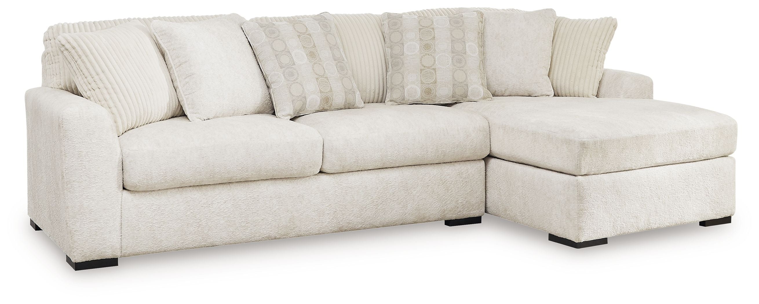Ivory sectional sofa with corner chaise, thick seat cushions, and stacked accent pillows