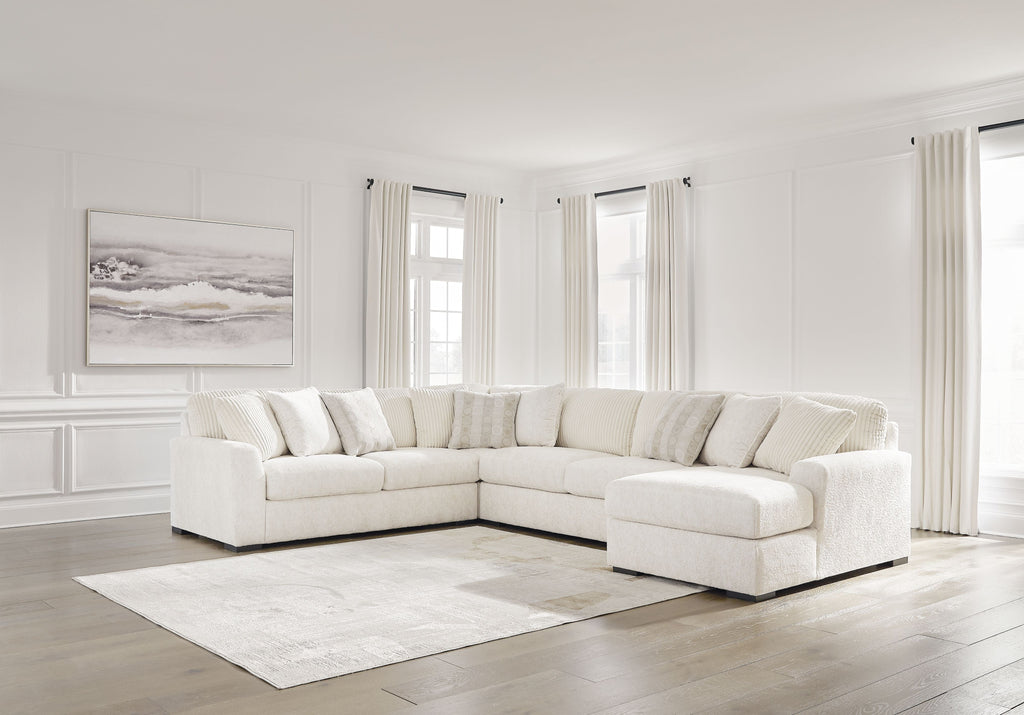 Ivory sectional sofa with corner chaise, plush cushions, and layered throw pillows