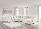 Ivory sectional sofa with corner chaise, plush cushions, and layered throw pillows