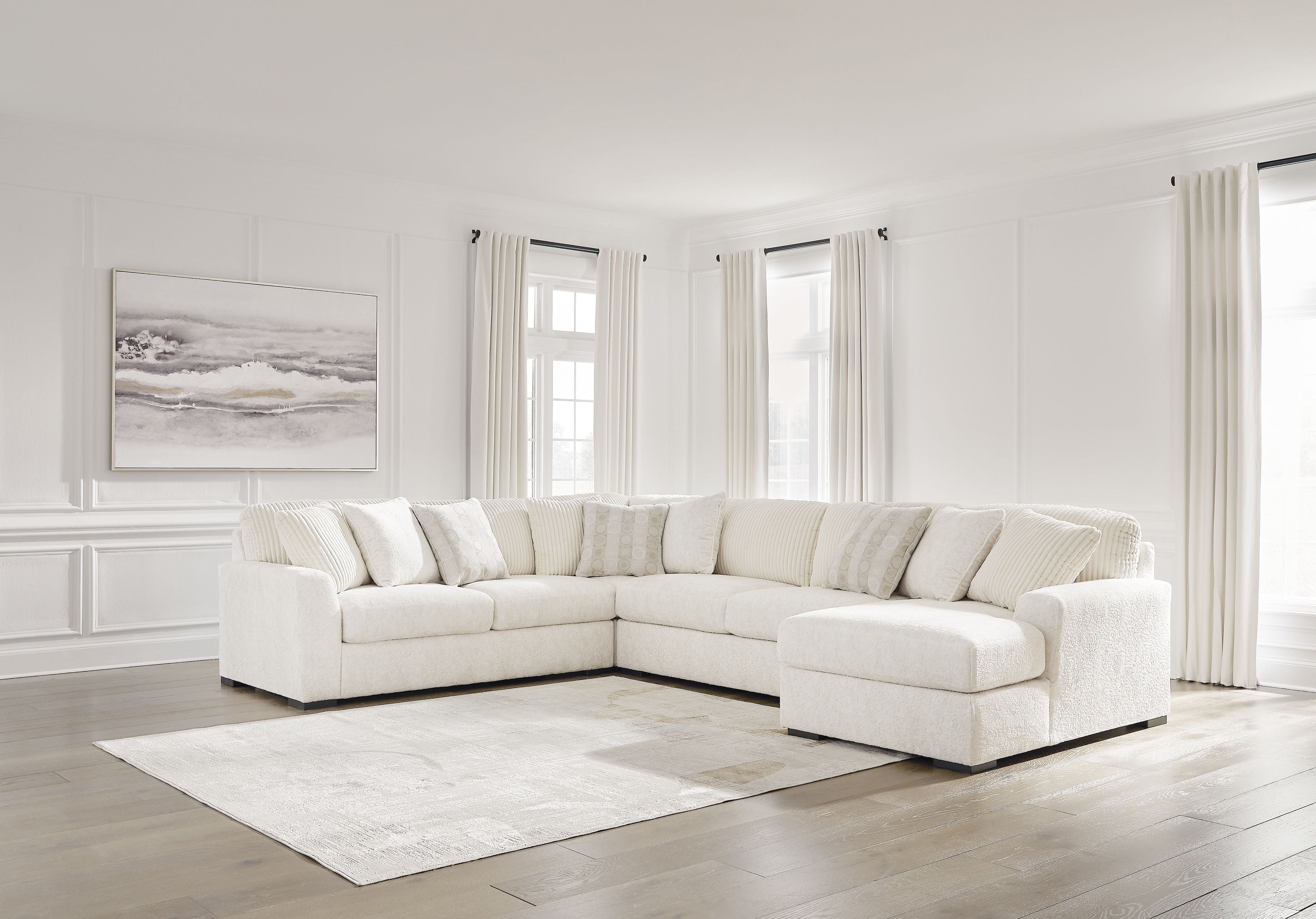 Ivory sectional sofa with corner chaise, plush cushions, and layered throw pillows