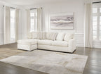 Ivory sectional sofa with chaise corner, wide seats, and multiple textured back cushions