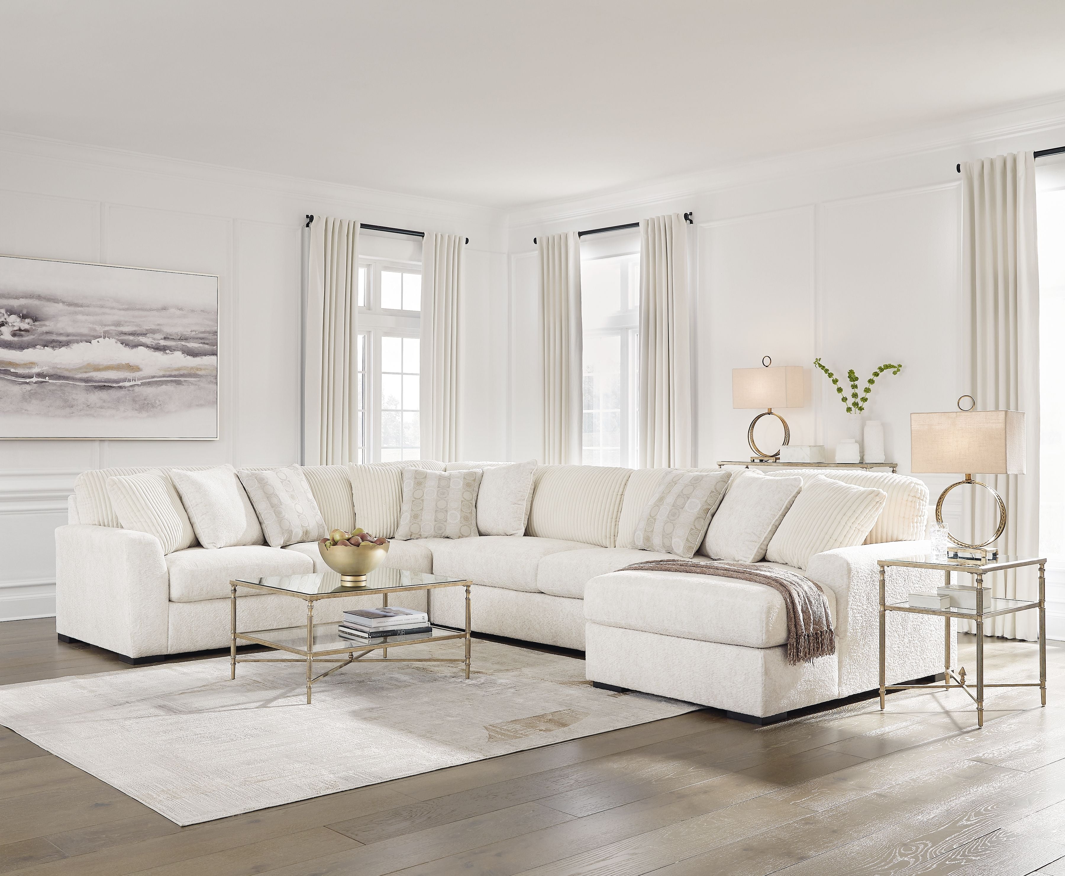Ivory sectional sofa with corner chaise, padded arms, and stacked back cushions
