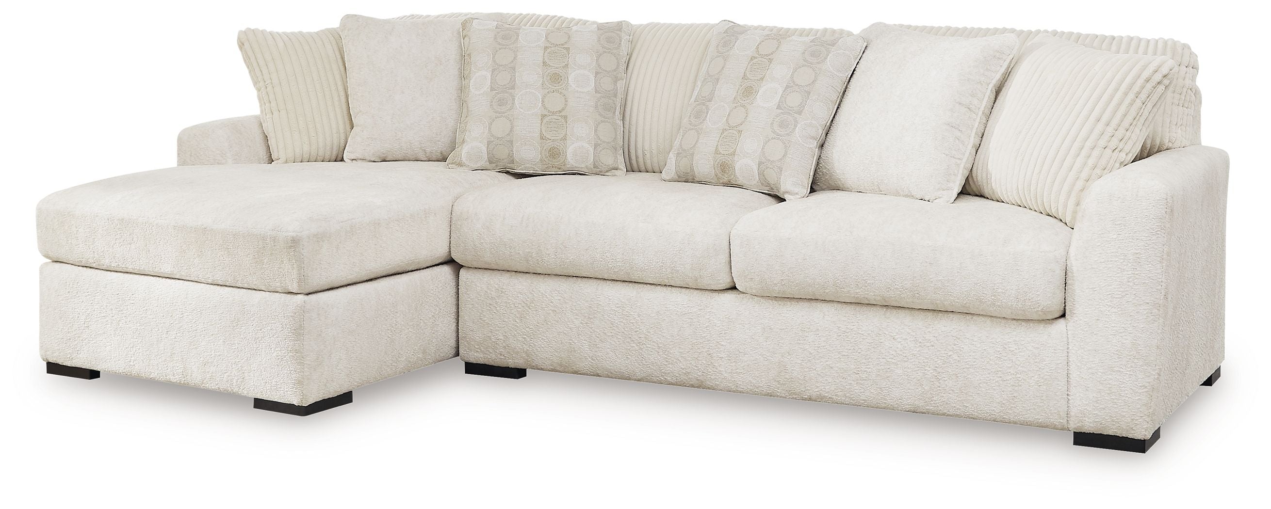 Ivory sectional sofa with corner chaise, plush seat cushions, and striped accent pillows