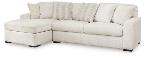 Ivory sectional sofa with corner chaise, plush seat cushions, and striped accent pillows