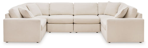 Light beige modular U-shaped sectional sofa with cushioned backs and chaise armrests