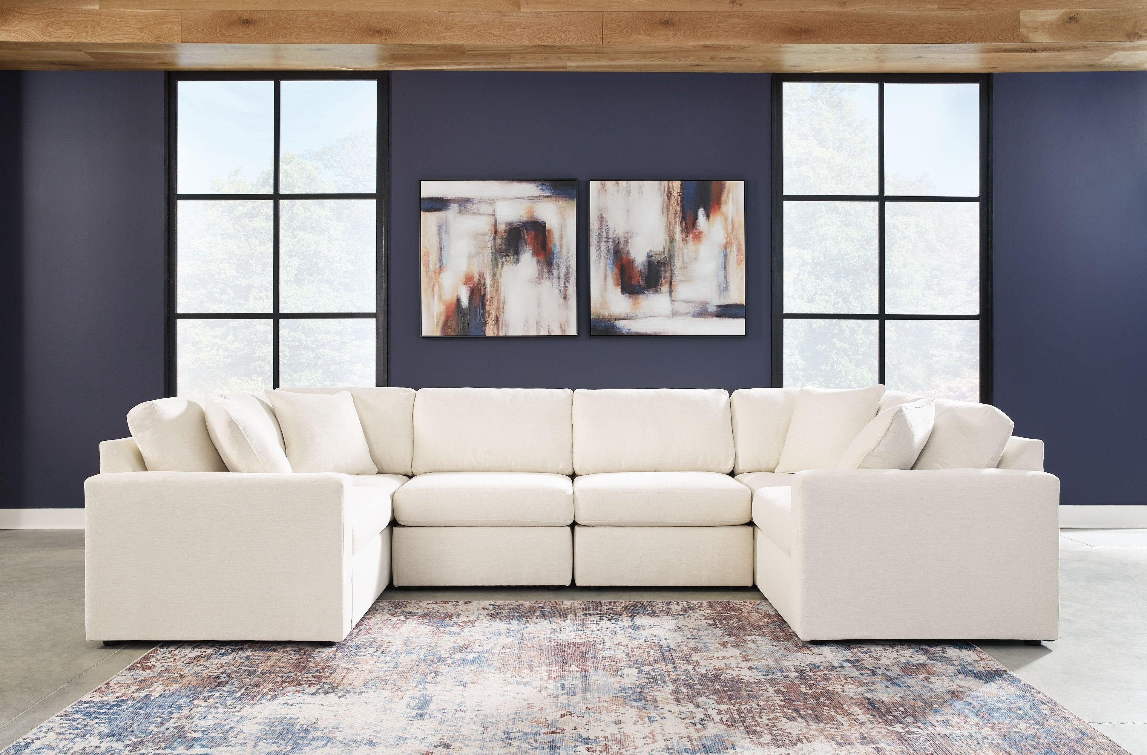 Cream modular U-shaped sectional sofa with chaise sections and pillow-back cushions