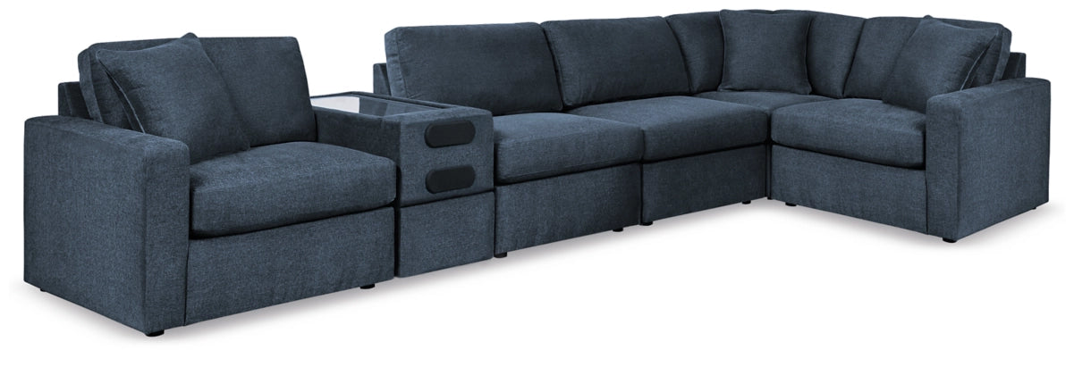 Modular sectional sofa in dark blue with chaise-style corner and tufted back cushions