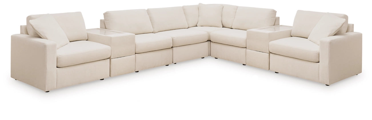 Modular sectional sofa in light cream fabric with rounded arms and plush seat cushions