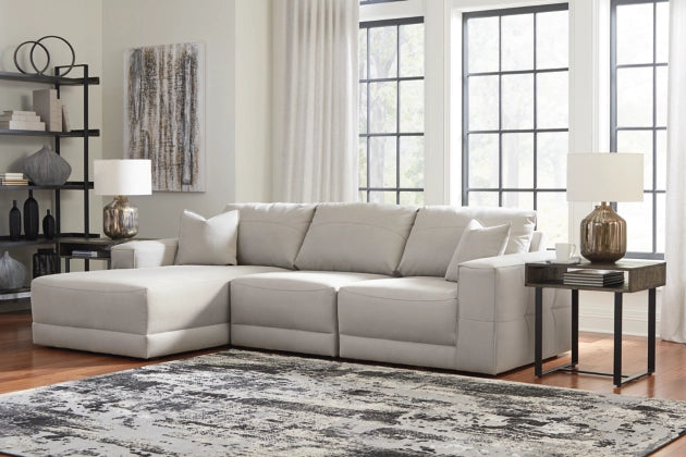 Light gray sectional sofa with chaise nook, tufted seat cushions and square arms