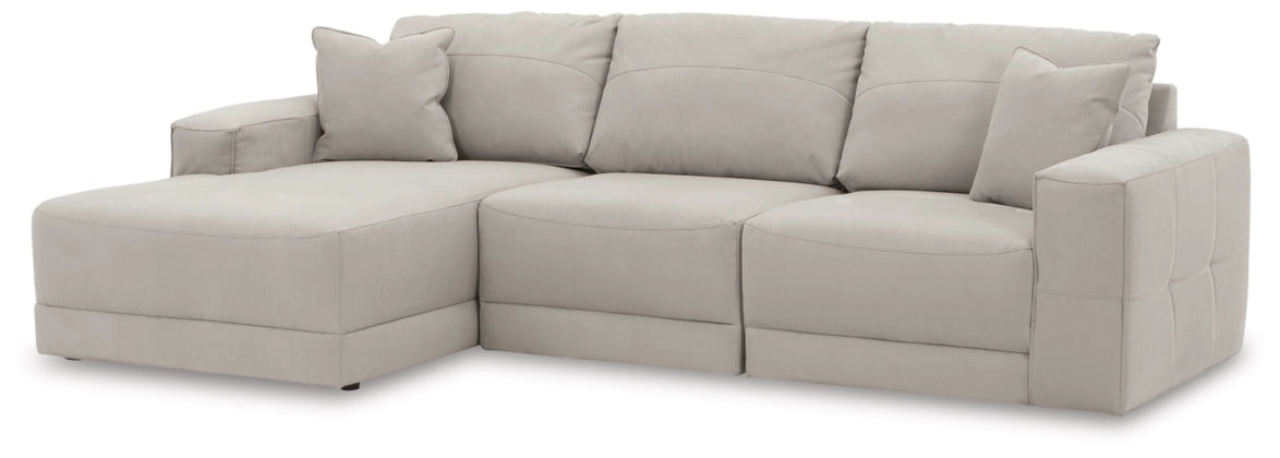Light gray sectional sofa with chaise and boxed cushions, square arms, tufted back pillows