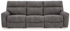Slate gray power reclining sectional sofa with three seat sections and padded back cushions