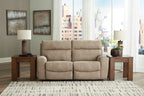 Sand beige power reclining sectional sofa with two power seats and tufted headrests in living room