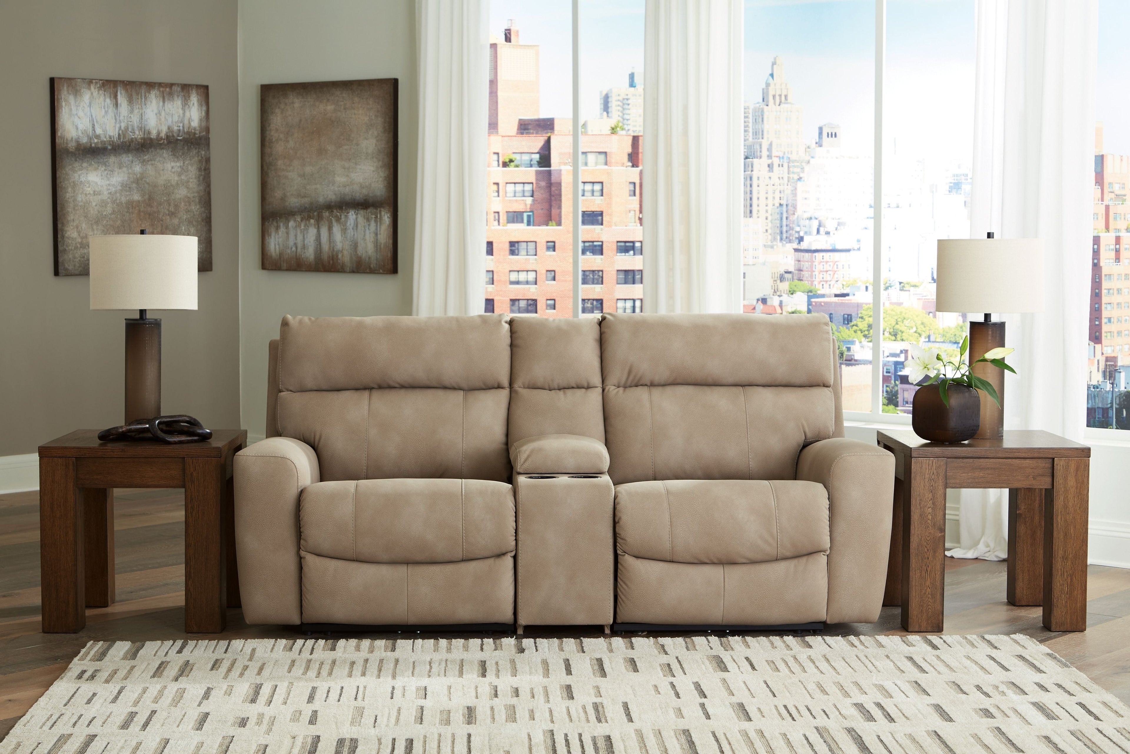 Sand beige power reclining sectional sofa with two-seat center section in a bright living room