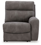 Power reclining armchair with cushioned back and padded arm, dark gray upholstery