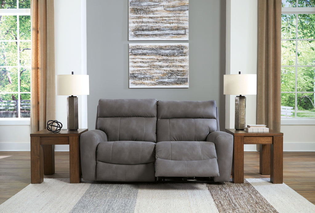 Power reclining loveseat with two seats and padded arms, dark gray fabric