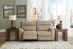 Power reclining loveseat with dual recline seats and padded arms, light beige upholstery