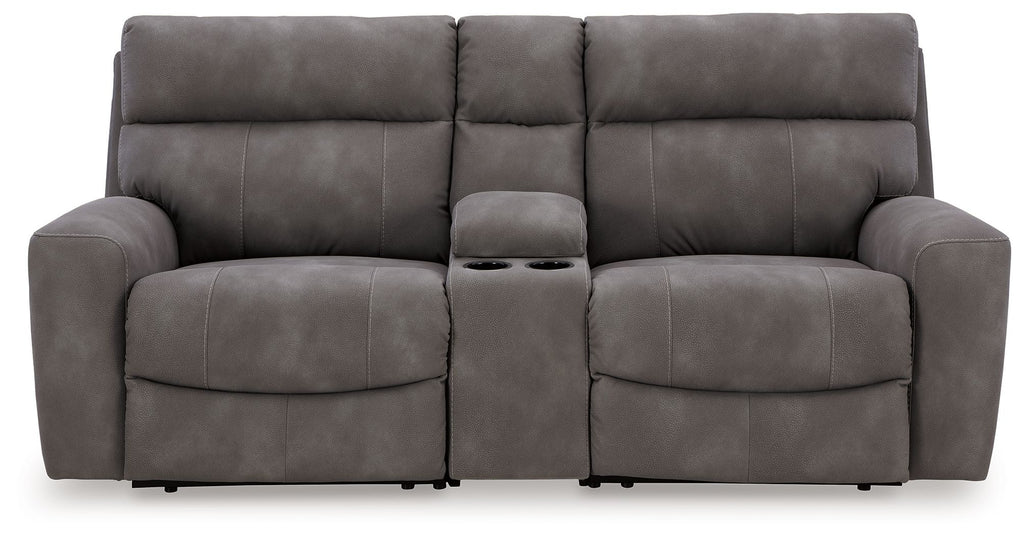 Power reclining sofa with three padded seats and chaise footrests, dark gray upholstery