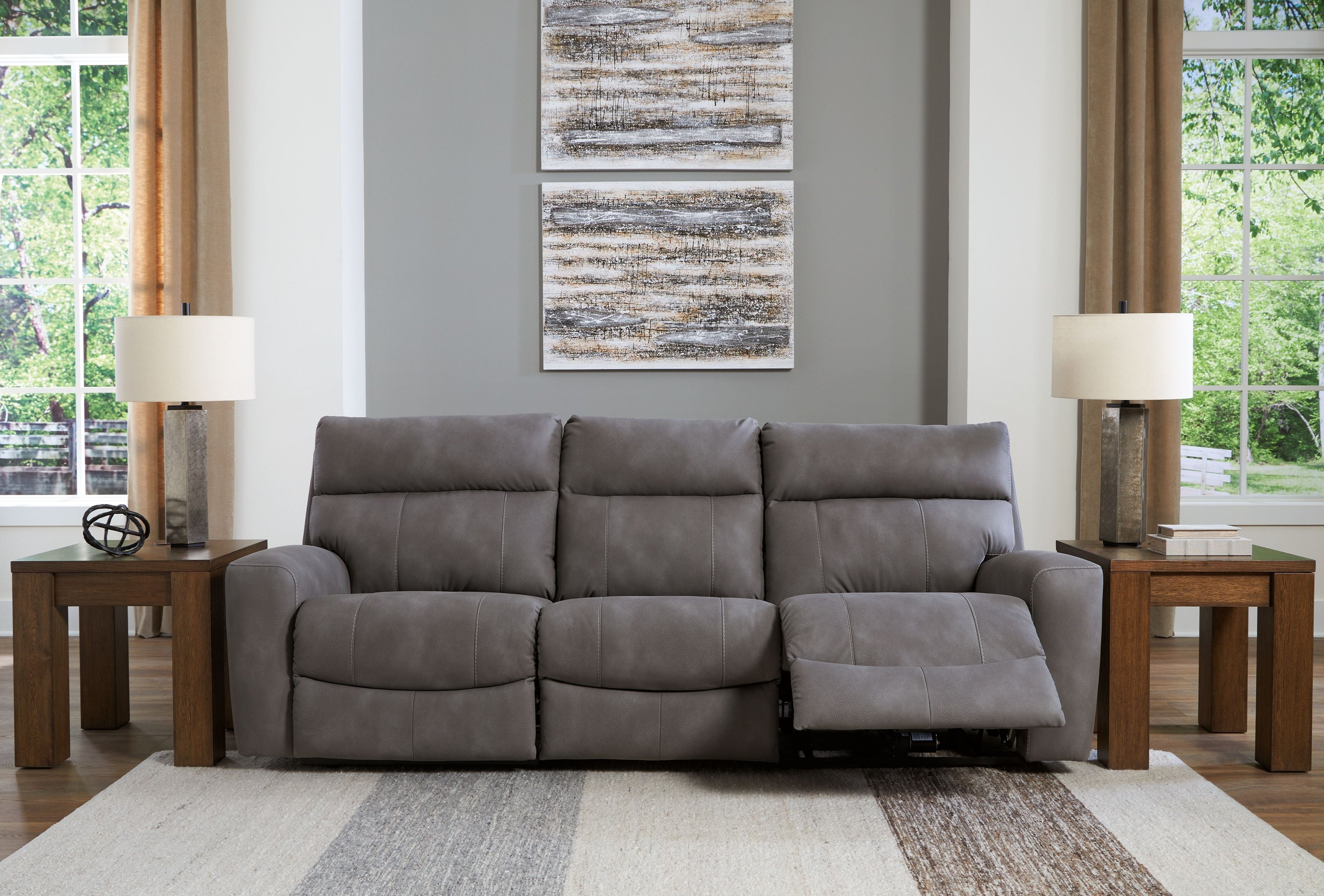 Gray power reclining sectional with three padded seats and extendable footrests