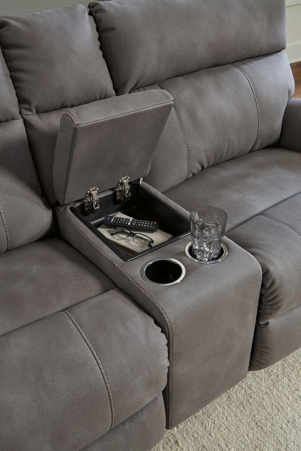 Gray recliner console with cup holders and recessed media control area
