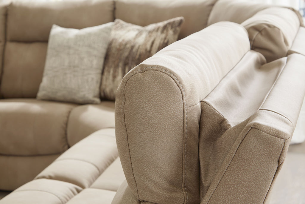 Cream power reclining sofa armrest with rounded back cushion and visible seams