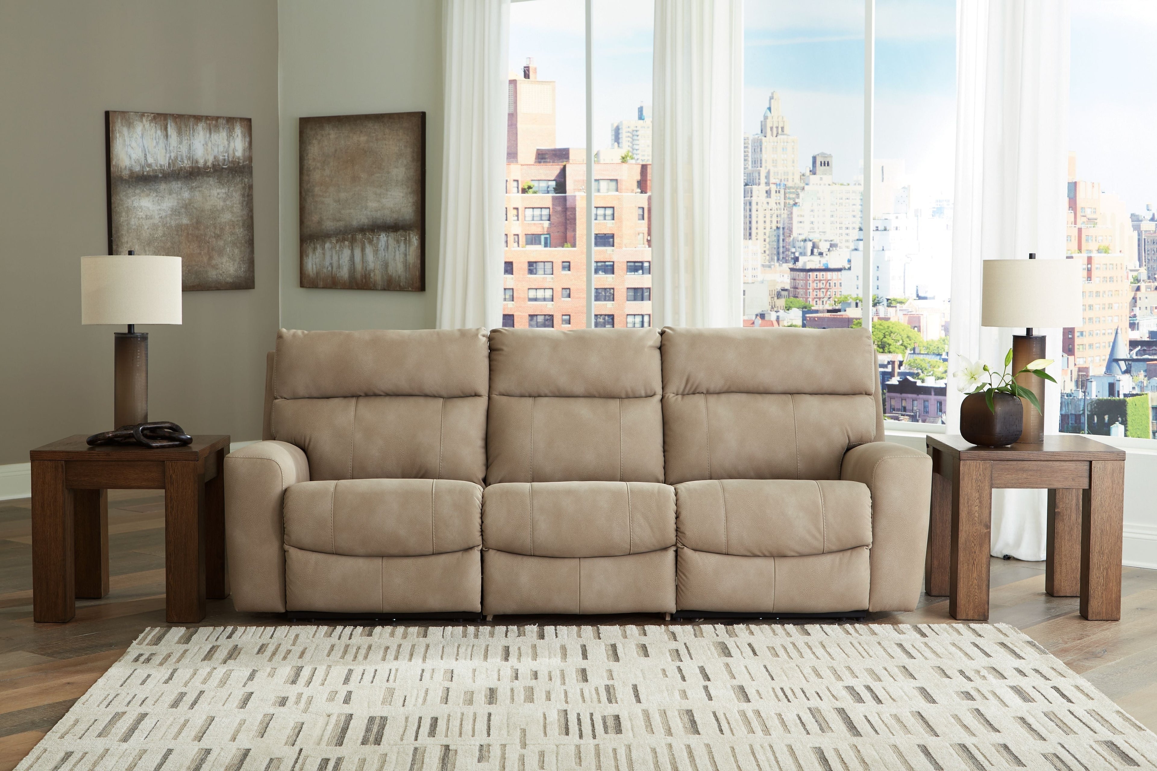Light beige power reclining sectional with three seat backs and square legs