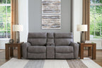Power reclining sectional sofa in dark gray fabric, with padded armrests and recline seats