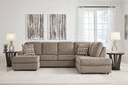 Gray sectional sofa with corner chaise, rolled-looking arm cushions, and pillows