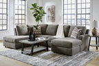 Gray sectional sofa with chaise ottoman, accent pillows, and square arm cushions