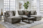 Gray sectional sofa with chaise ottoman, back cushions, and decorative throw pillows