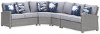 Light gray outdoor sectional sofa with corner and blue patterned pillows