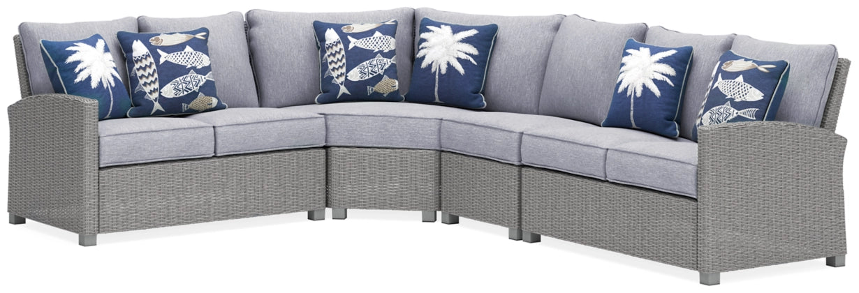 Light gray outdoor sectional sofa with corner and blue patterned pillows