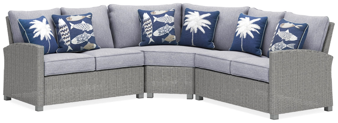 Light gray outdoor sectional sofa with three back cushions and blue patterned pillows
