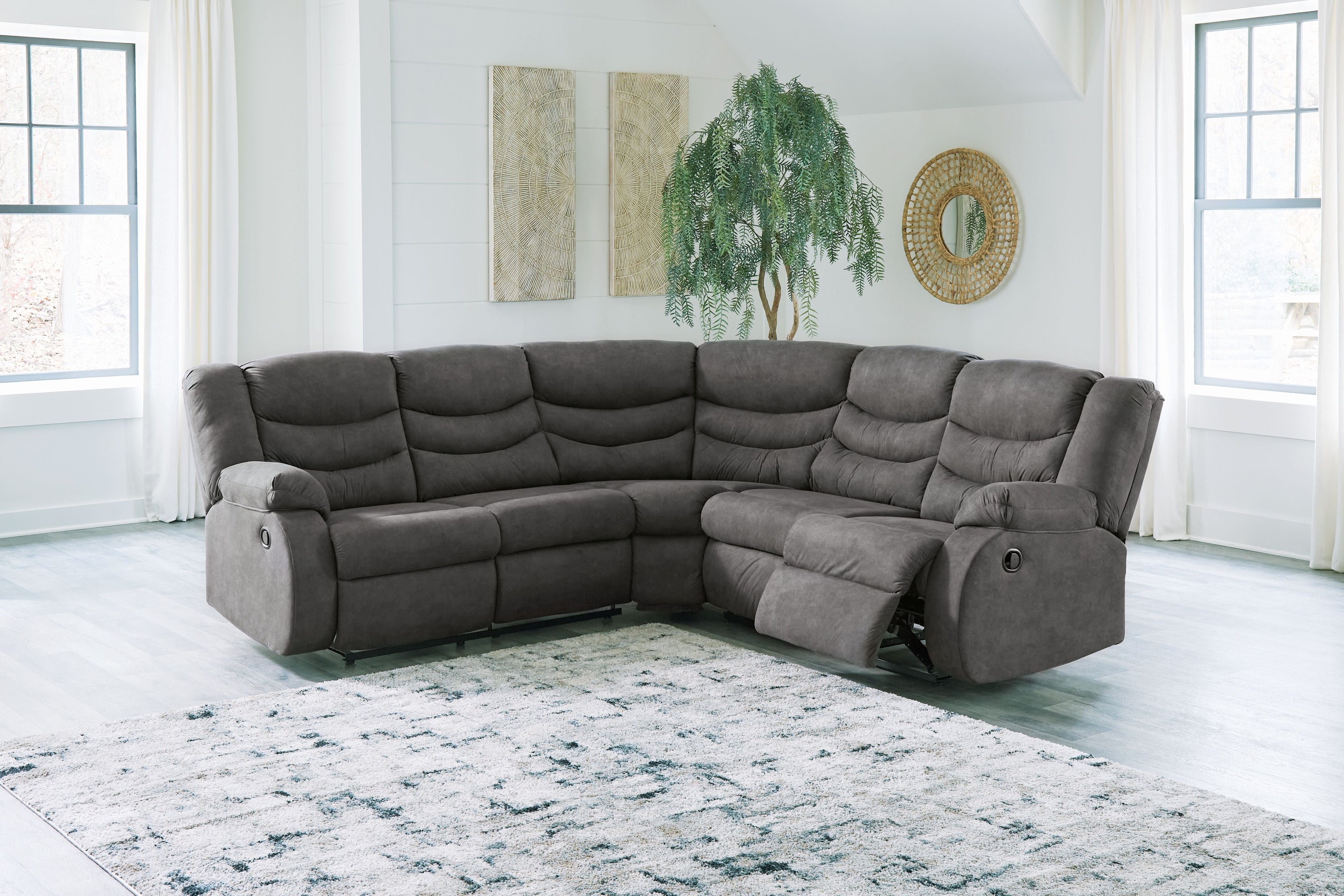 Slate gray reclining sectional sofa with chaise, padded arms, and tufted back cushions