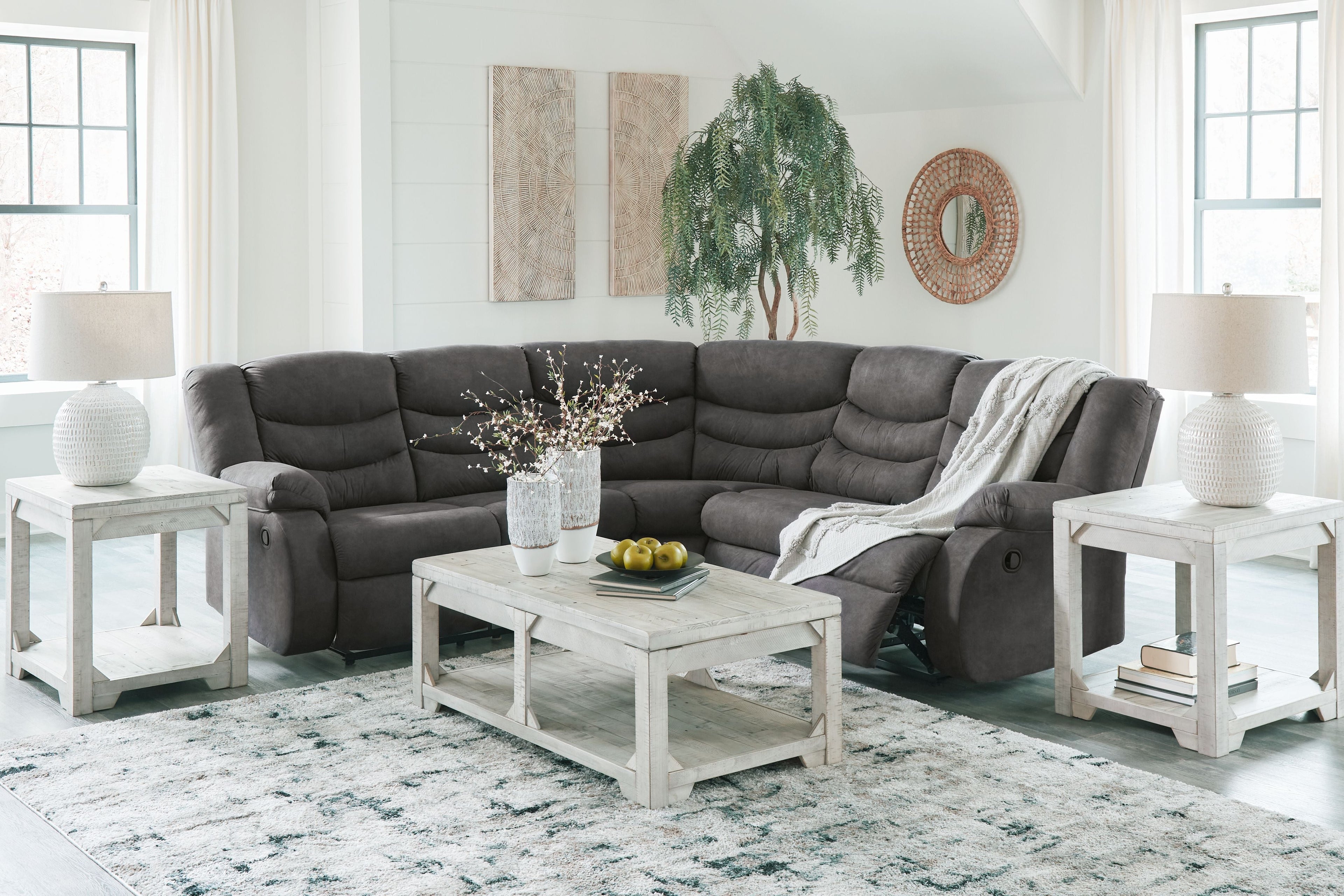 Slate gray reclining sectional sofa with chaise extension and armchair-style back cushions