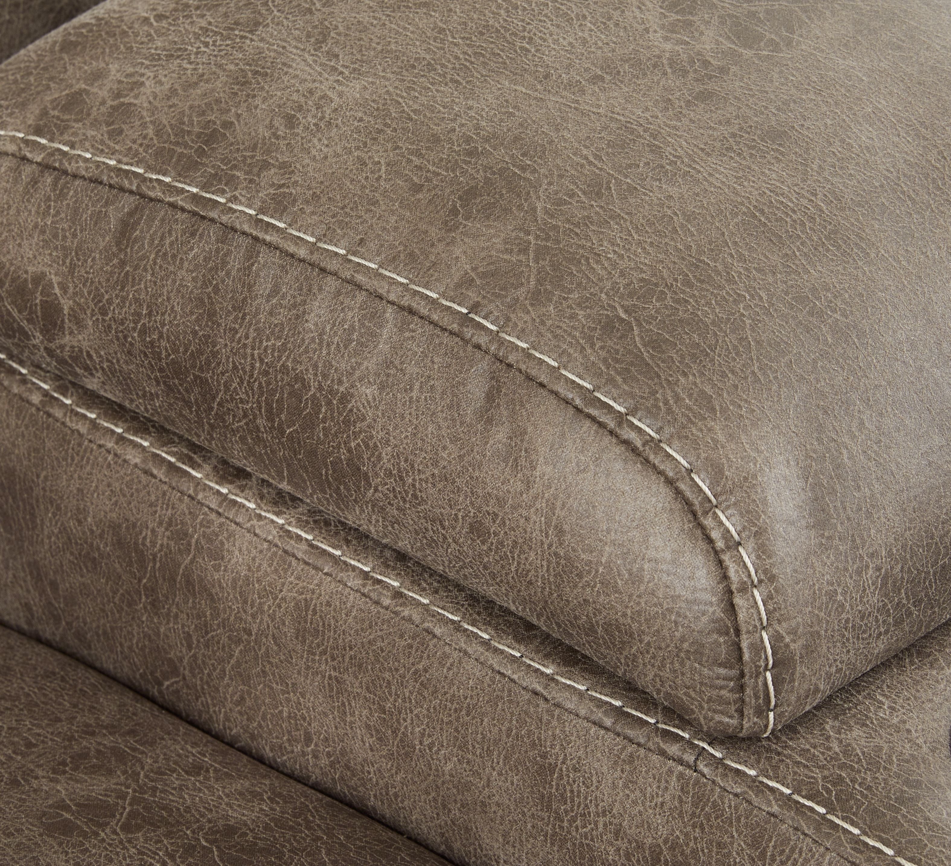 Close-up of dark taupe upholstery with stitched seam detail on the recliner arm