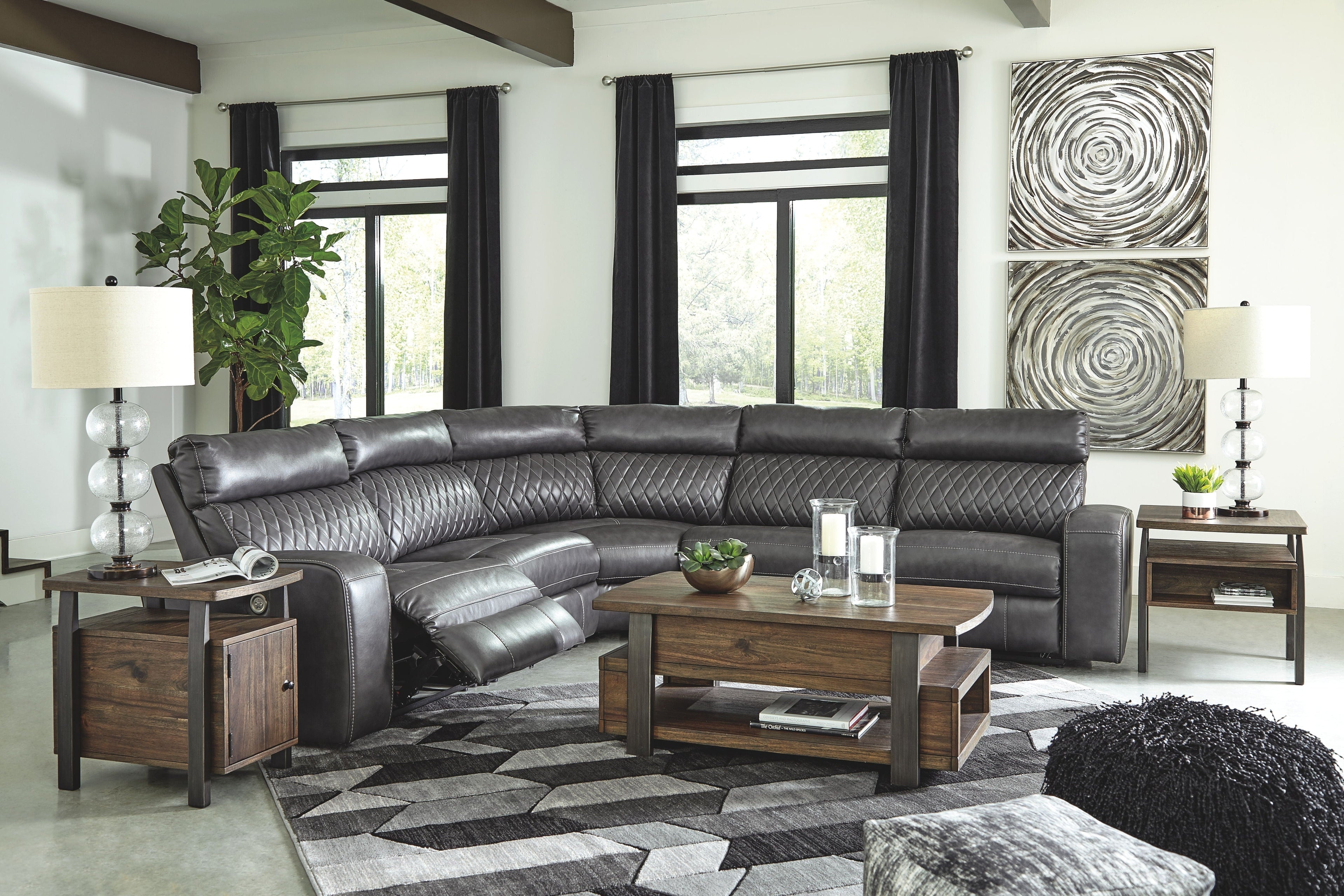 Dark gray power reclining sectional with padded armrests and multiple seats