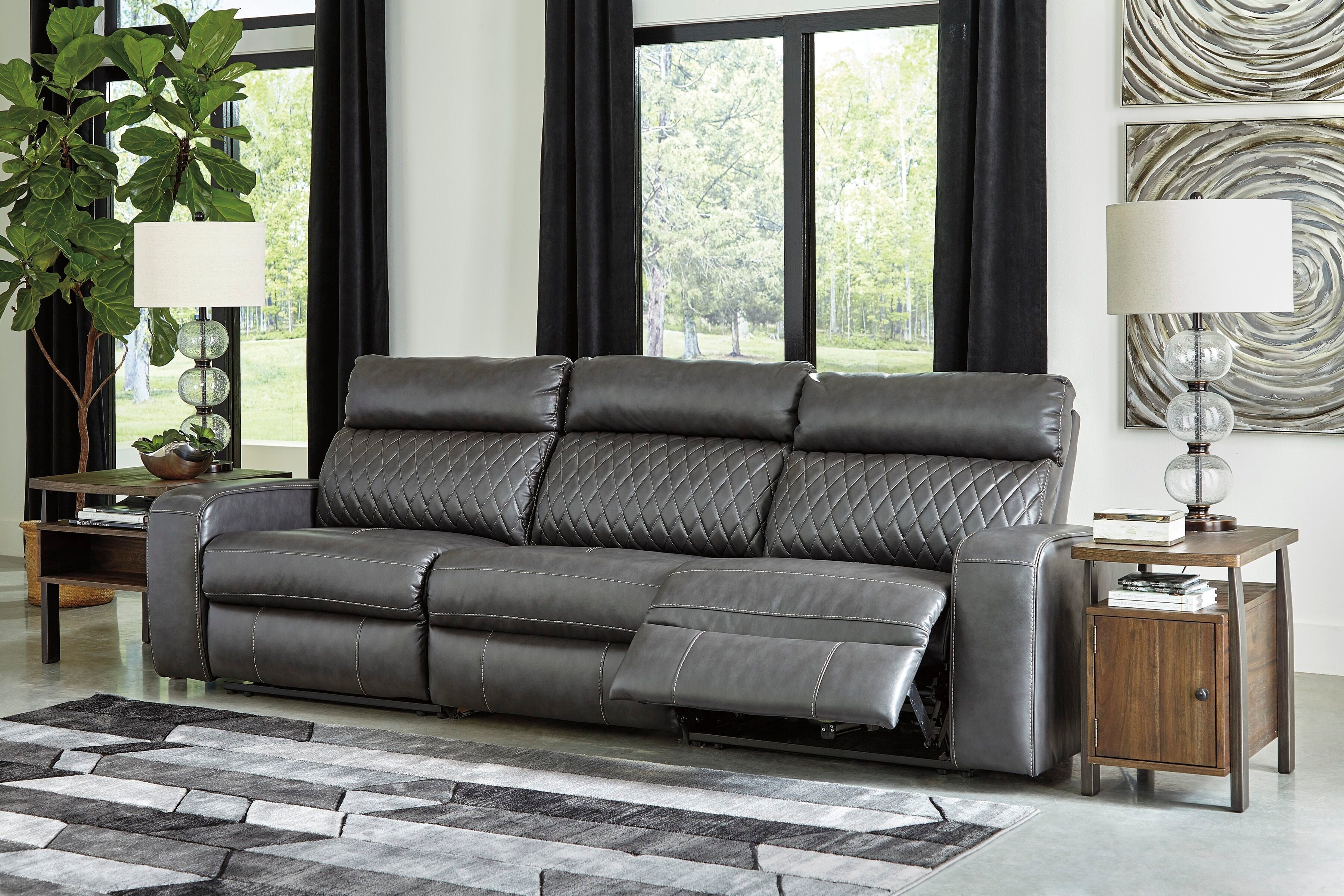 Gray power reclining loveseat with adjustable footrests and diamond back paneling